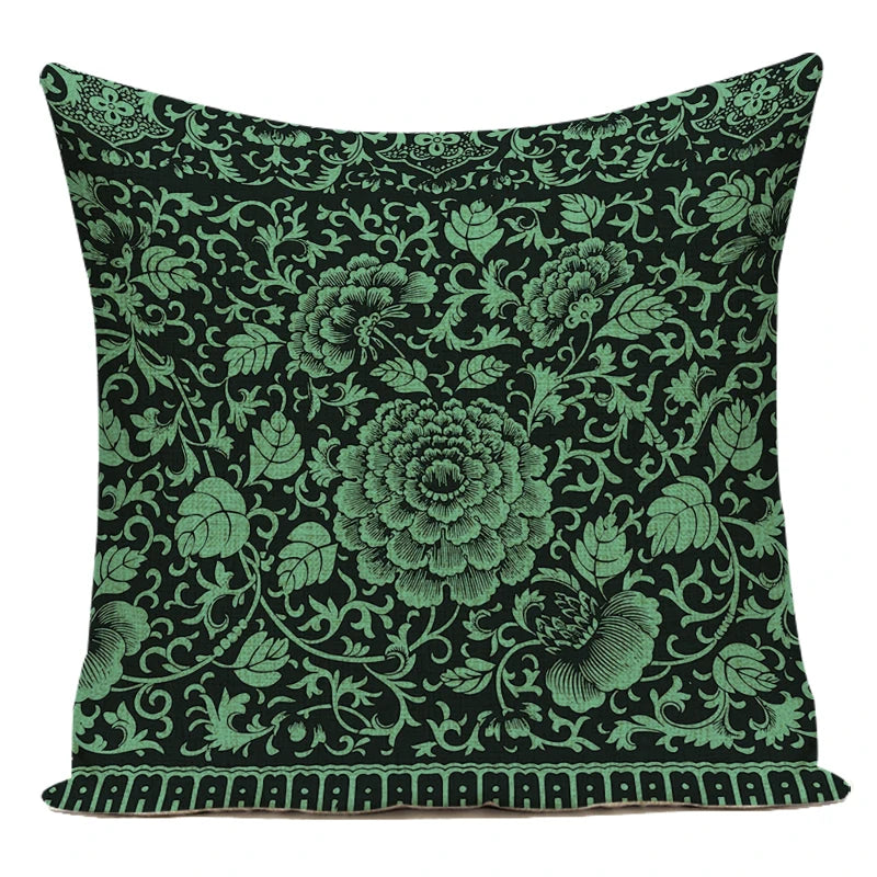 Decorative pillow with green floral pattern on a black background
