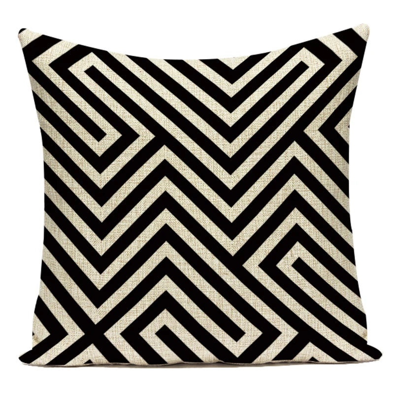 Decorative pillow with black and white geometric pattern on a white background