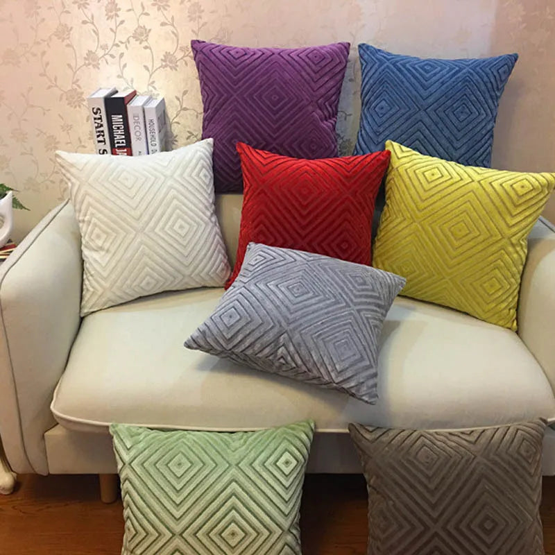 Colorful textured pillows on a beige sofa against a floral wallpaper background