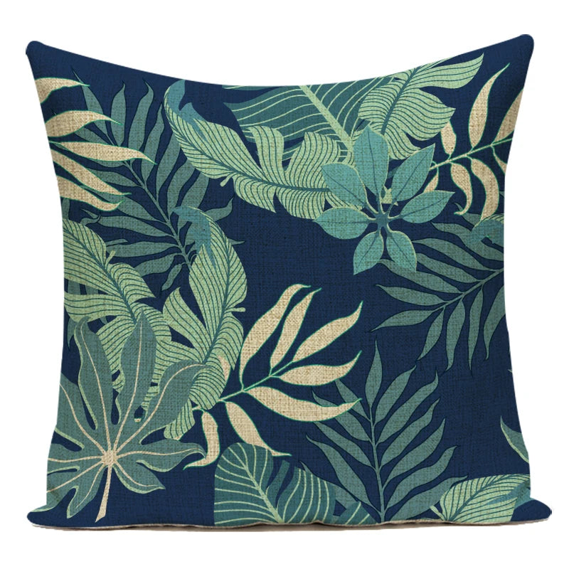 Decorative pillow with tropical leaf pattern on a navy background