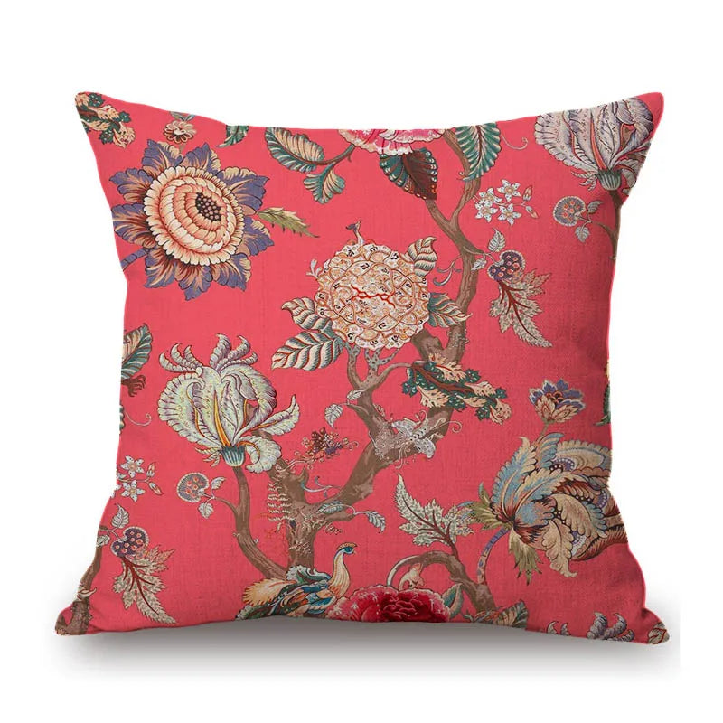 Decorative pillow with floral and bird pattern on a red background