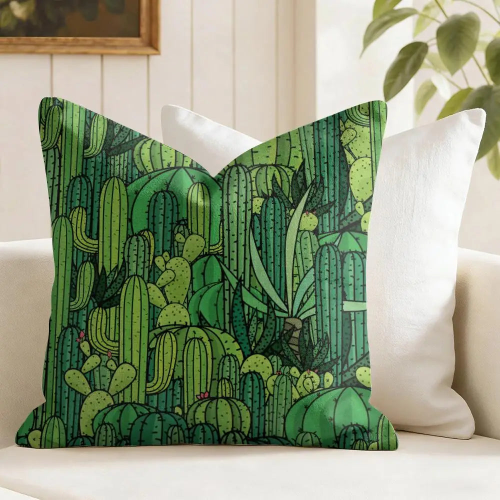 Green cactus patterned pillow on a white couch