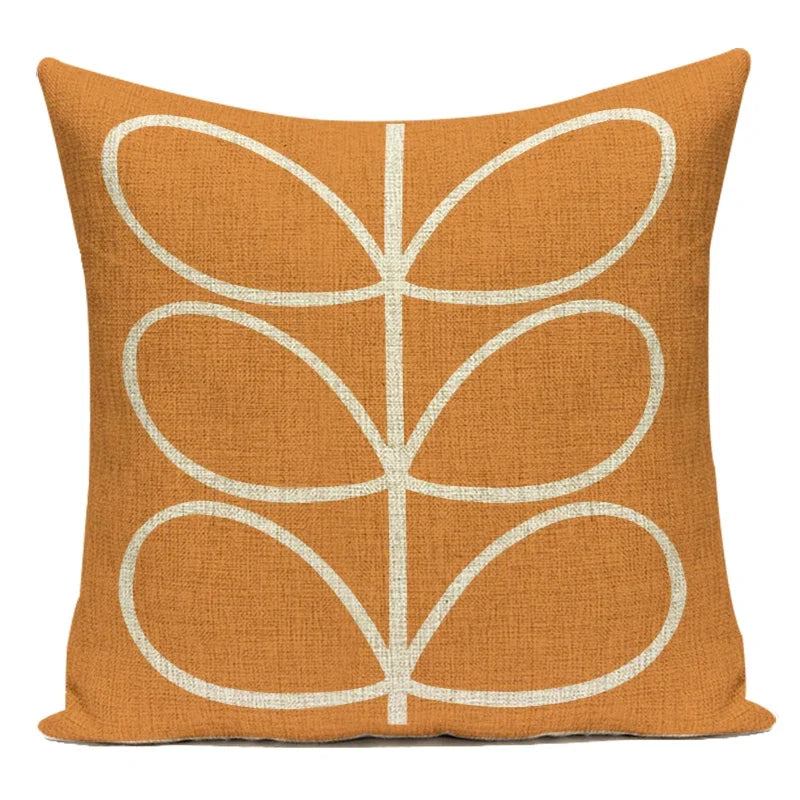 Orange pillow with white geometric pattern on a white background