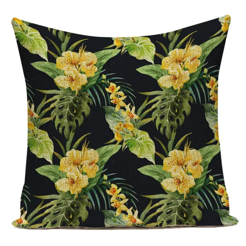 Decorative pillow with yellow floral and green leaf pattern on a black background