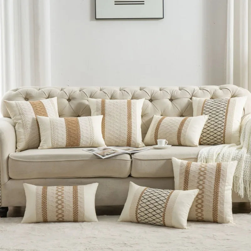 Beige sofa with patterned cushions in a living room setting