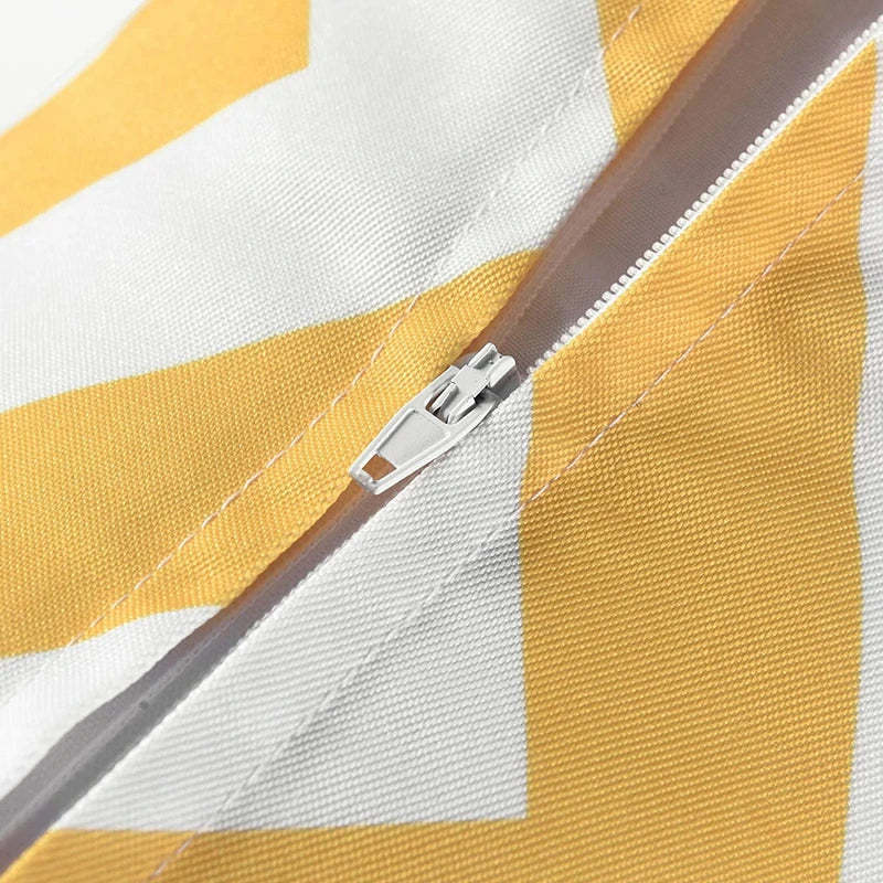 Close-up of a yellow and white striped fabric with a zipper
