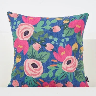 Floral-patterned pillow with pink flowers on a blue background