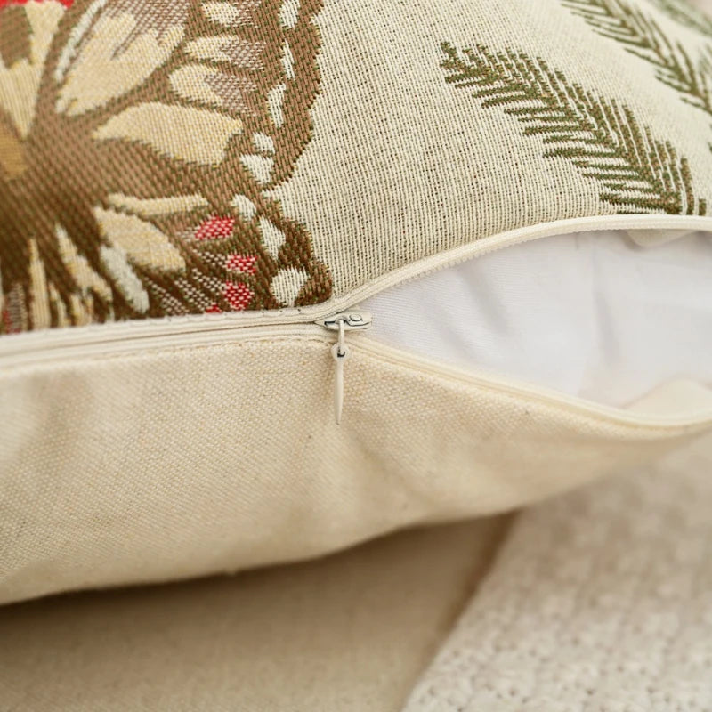 Close-up of a decorative pillow with floral patterns on a neutral background