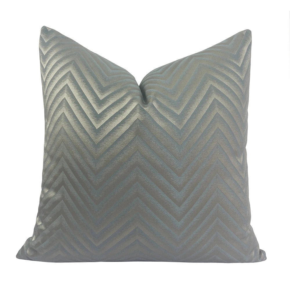 Gray chevron patterned pillow on a white background