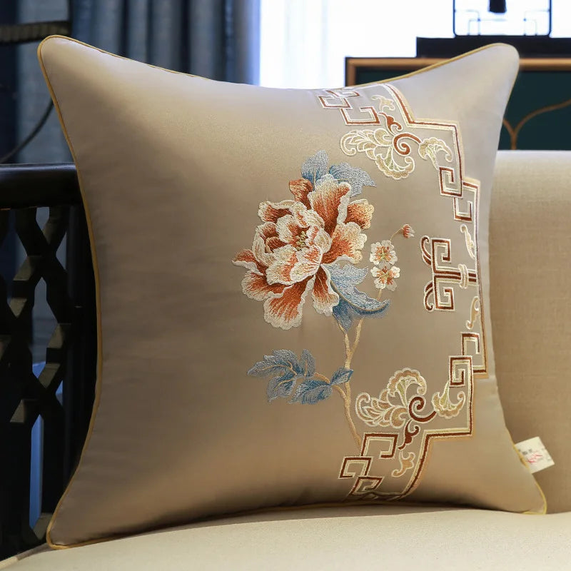 Decorative pillow with floral embroidery on a beige background