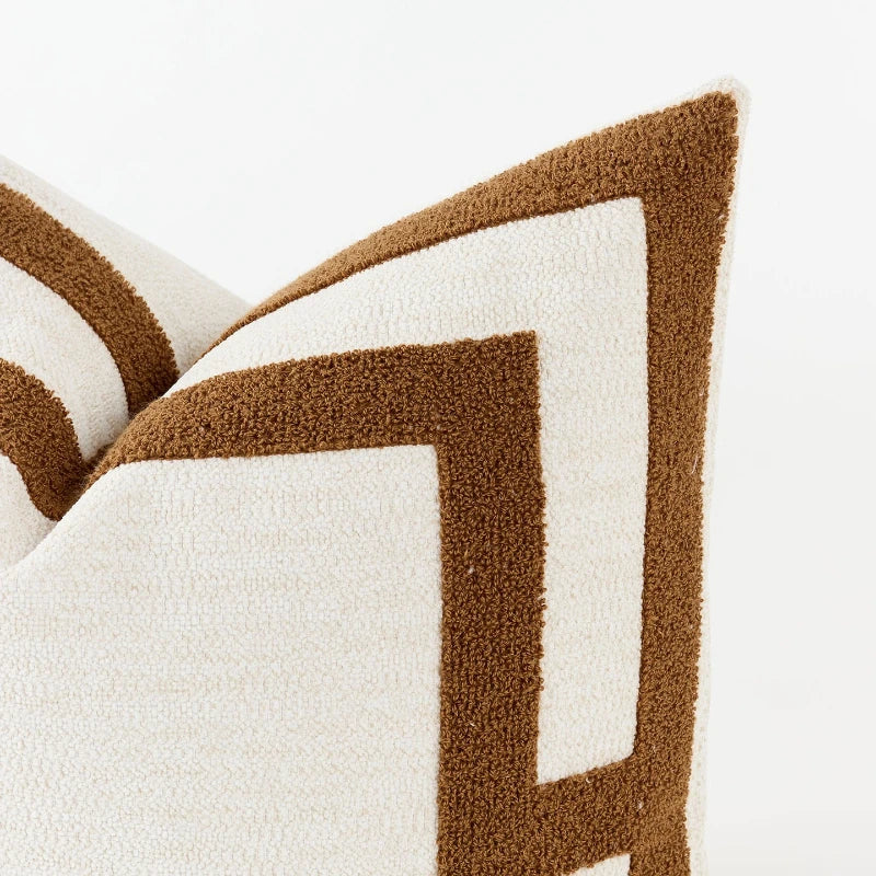 Close-up of a brown and white patterned pillow on a white background