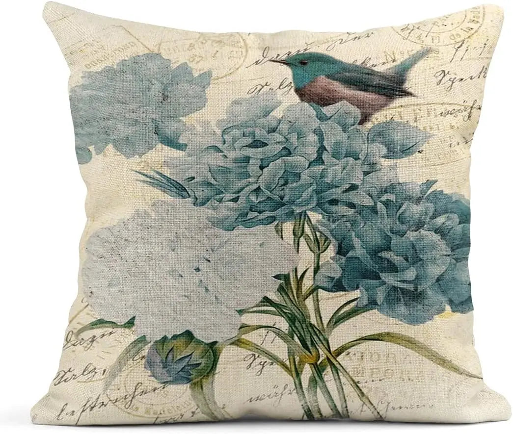 Decorative pillow with floral and bird design on a beige background