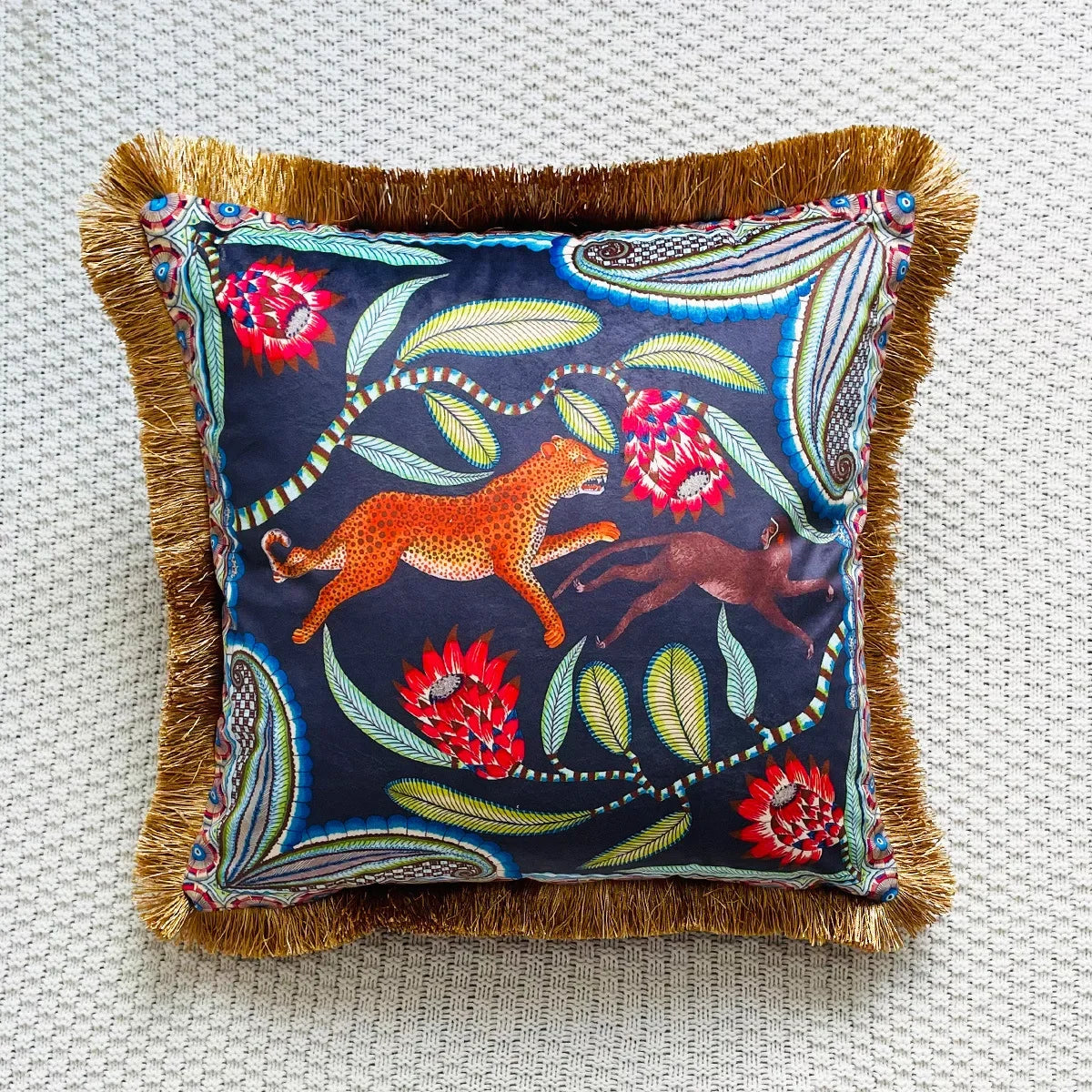 Decorative pillow with animal and floral embroidery on a textured surface