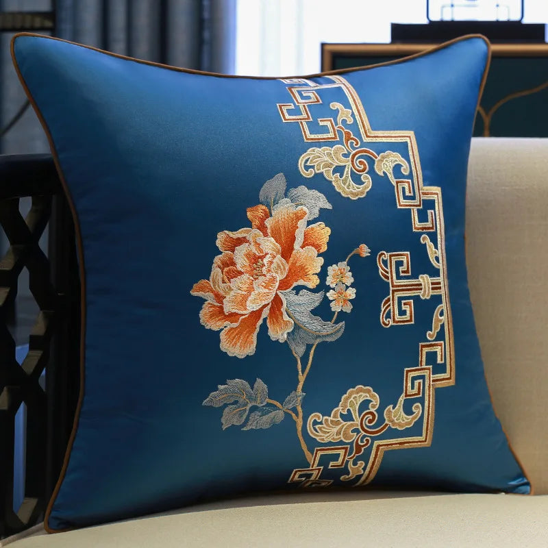 Decorative pillow with floral embroidery on a blue background