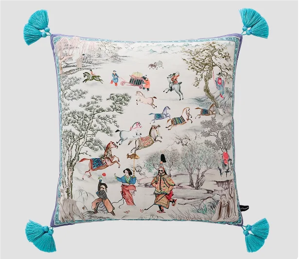 Decorative pillow with intricate patterns and tassels on a light background