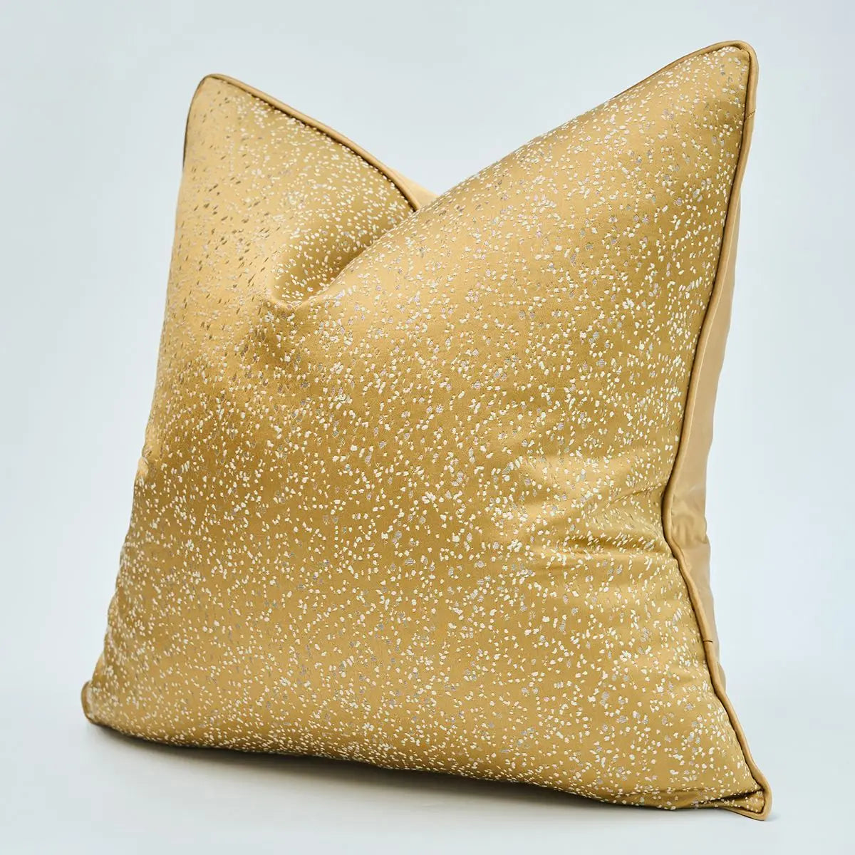 Gold glittery pillow on a light gray background