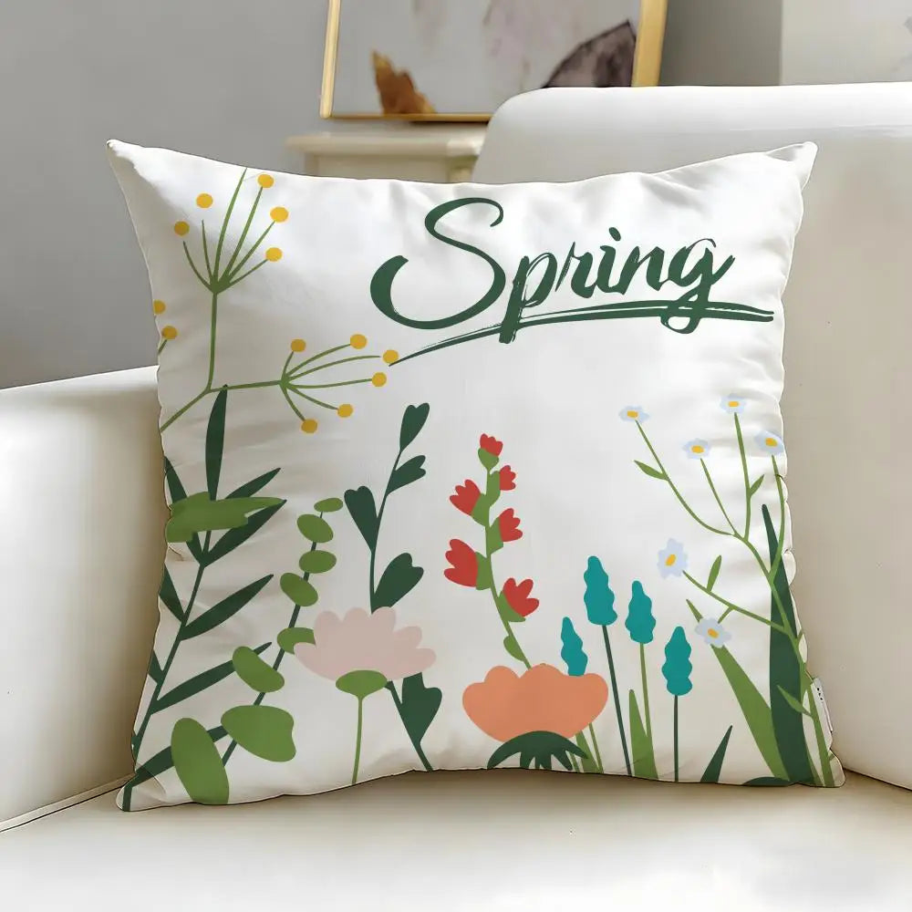 Decorative pillow with floral design and 'Spring' text on a white couch.