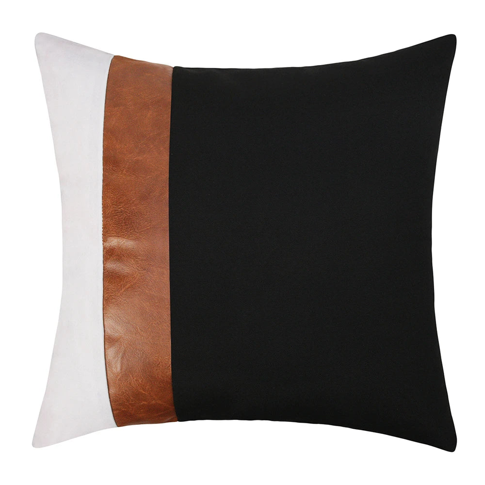 Decorative pillow with black, white, and brown color block design on a white background