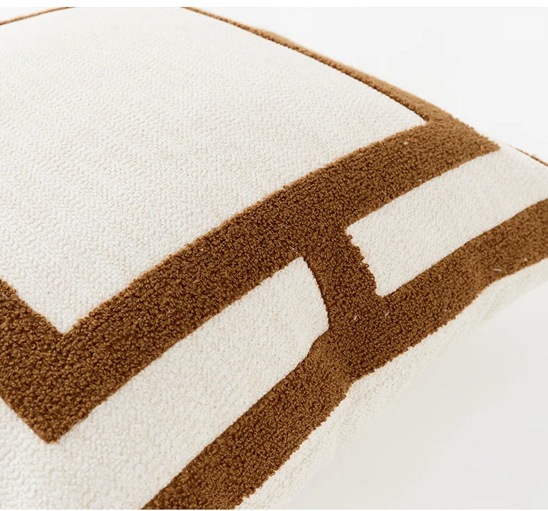 Close-up of a textured pillow with brown and white chevron pattern on a white background