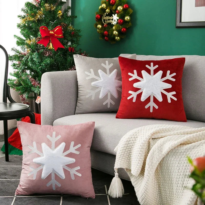 Decorative pillows with snowflake patterns on a couch in a festive living room.