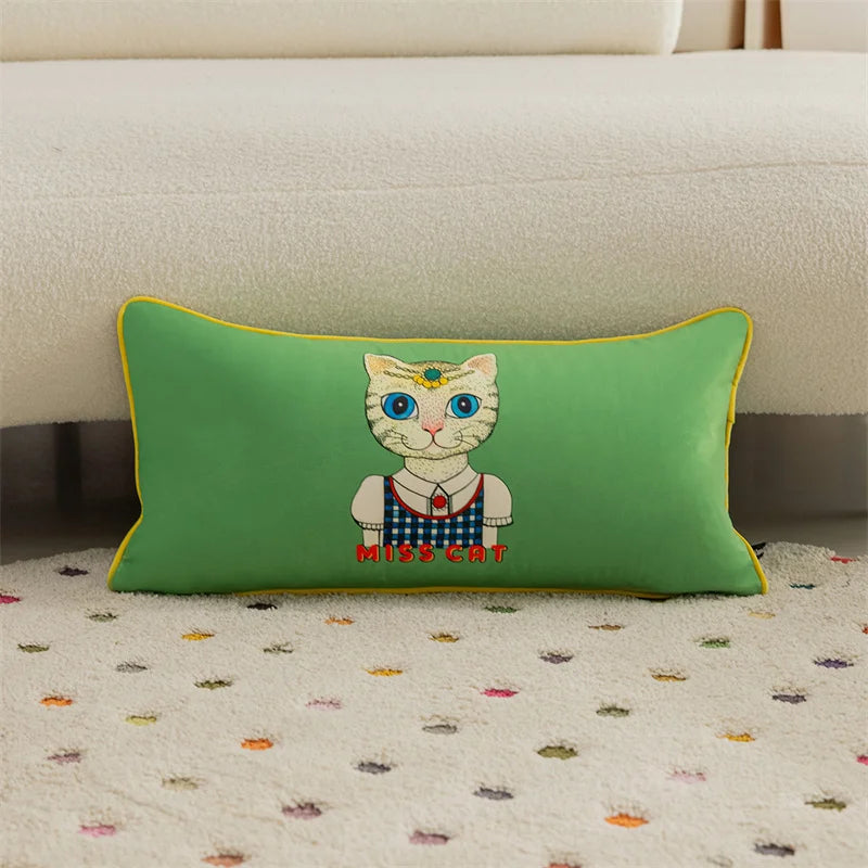 Green pillow with a cat illustration on a patterned carpet