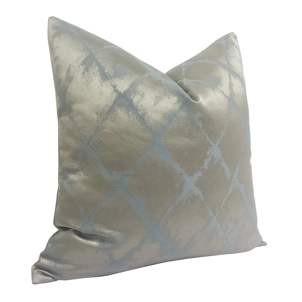 Decorative pillow with a silver and blue pattern on a white background