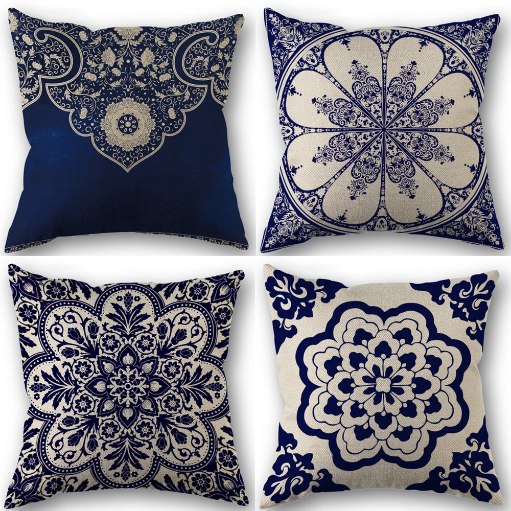 Four decorative pillows with blue and white floral patterns on a white background
