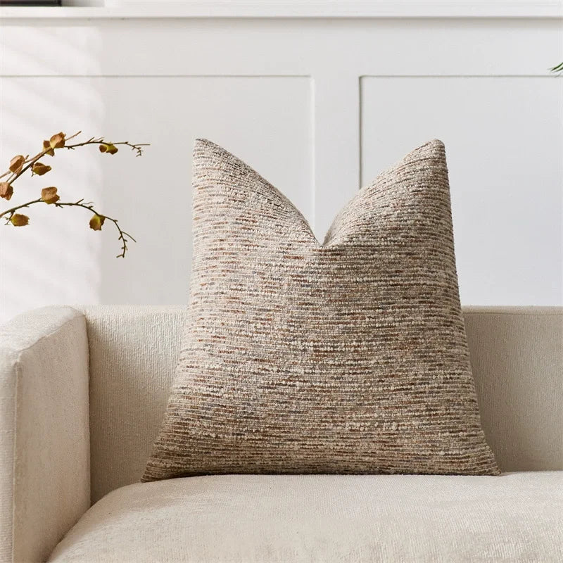 Brown striped boucle pillow cover with woven texture on couch