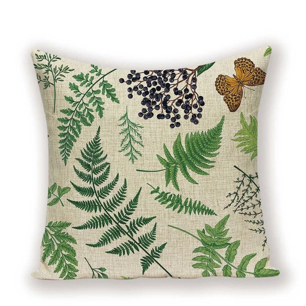 Decorative pillow with green leaf pattern on a beige background