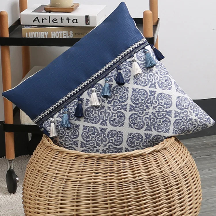Decorative pillow with blue and white pattern on a wicker stool
