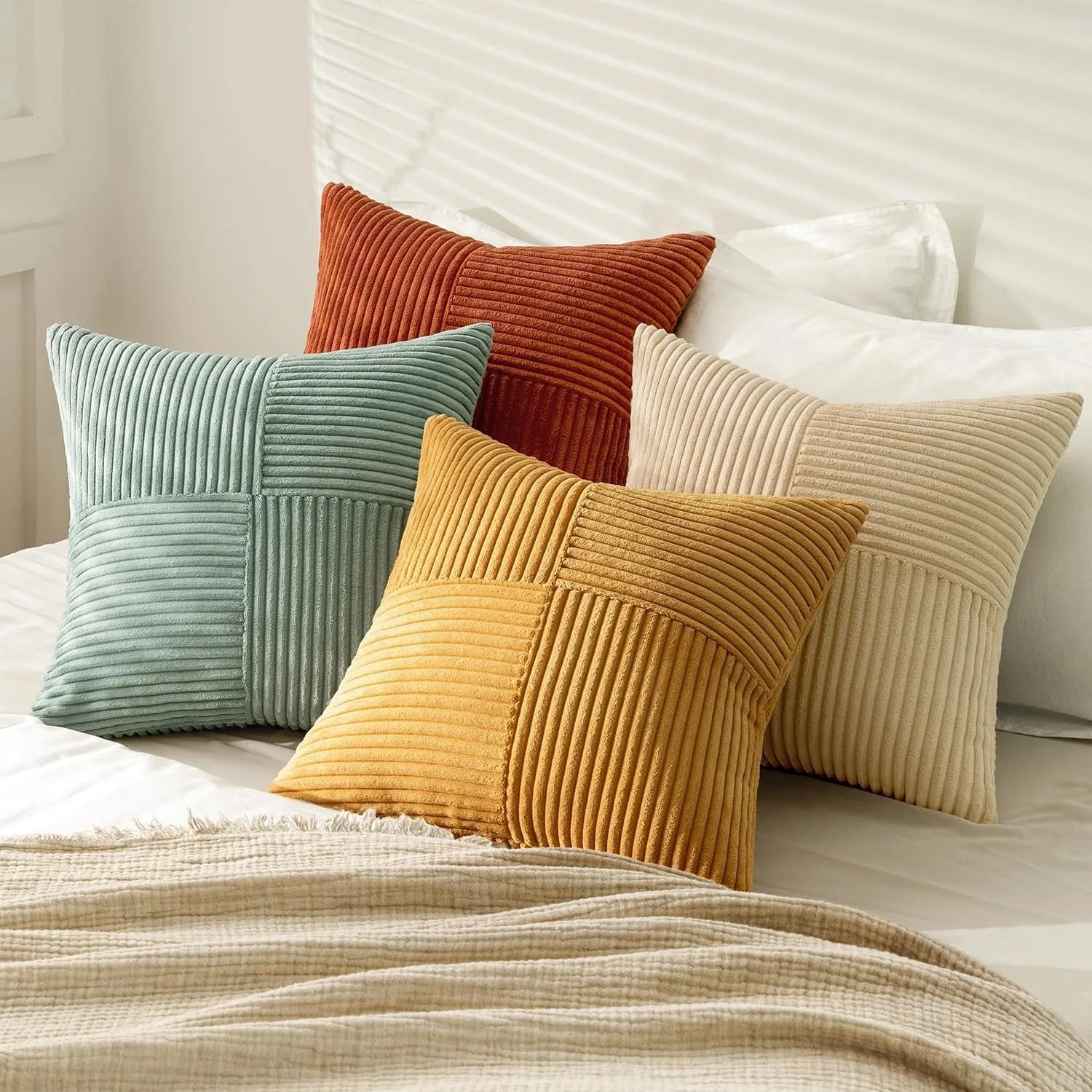 Green and yellow corduroy pillow covers on bed with soft texture