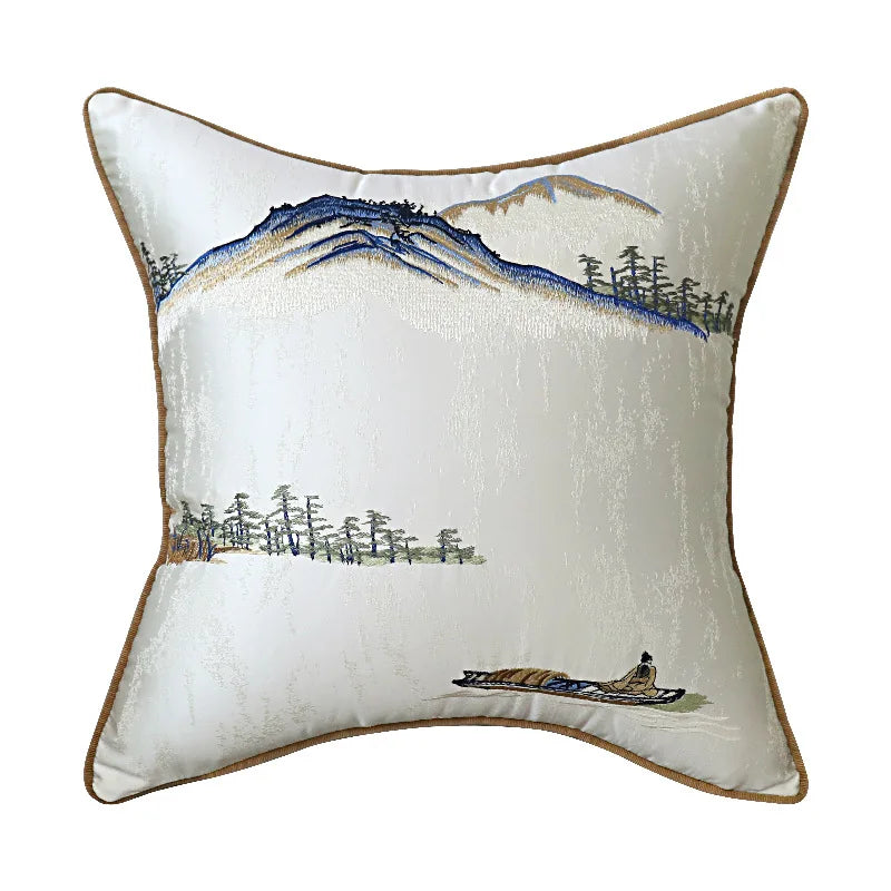 Decorative pillow with mountain and boat design on a white background