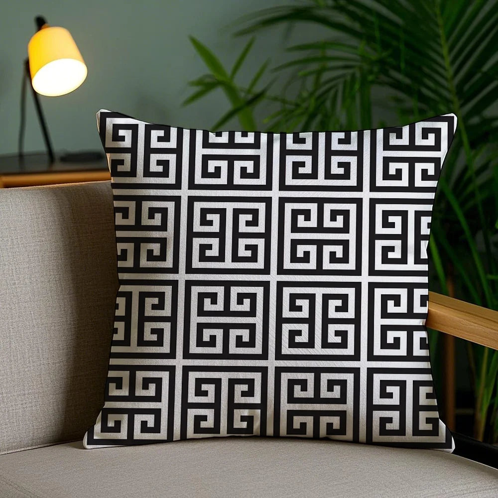 Decorative pillow with black and white pattern on a couch