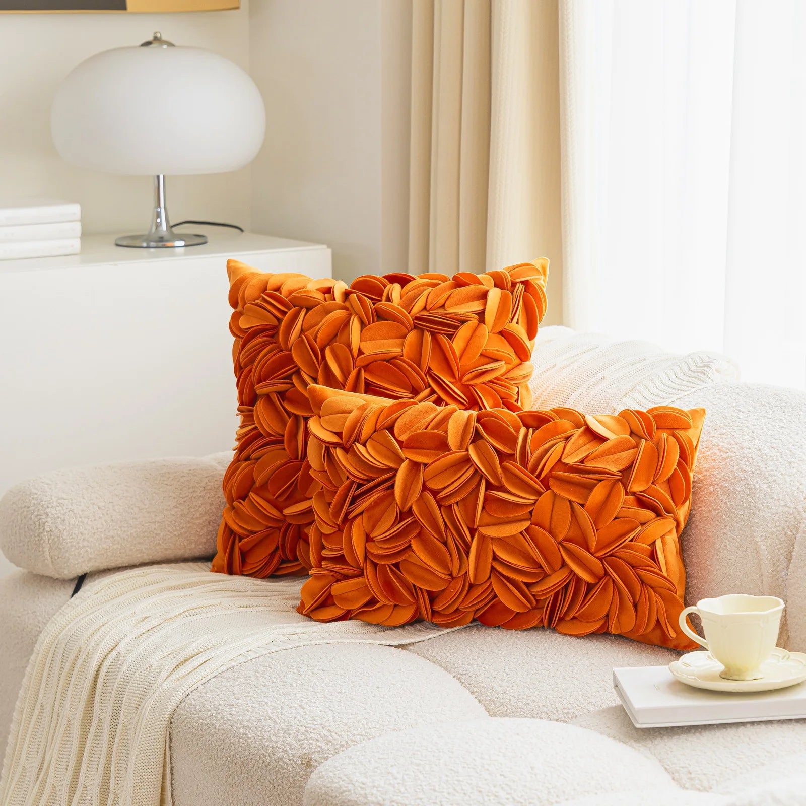 Orange luxury velvet pillow cover with floral petal embroidery and elegant textured design