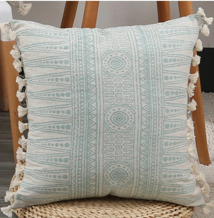 Decorative pillow with geometric pattern and tassels on a chair