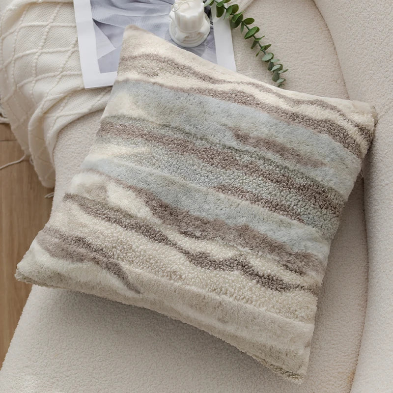 Striped pillow on a sofa with a neutral color scheme