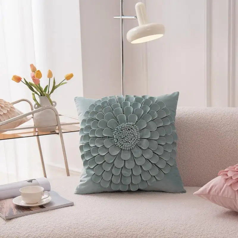 Green plush velvet pillow cover with textured flower pattern on sofa