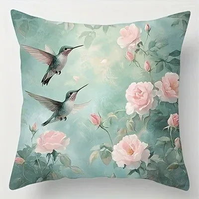 Decorative pillow with hummingbirds and pink roses on a light green background