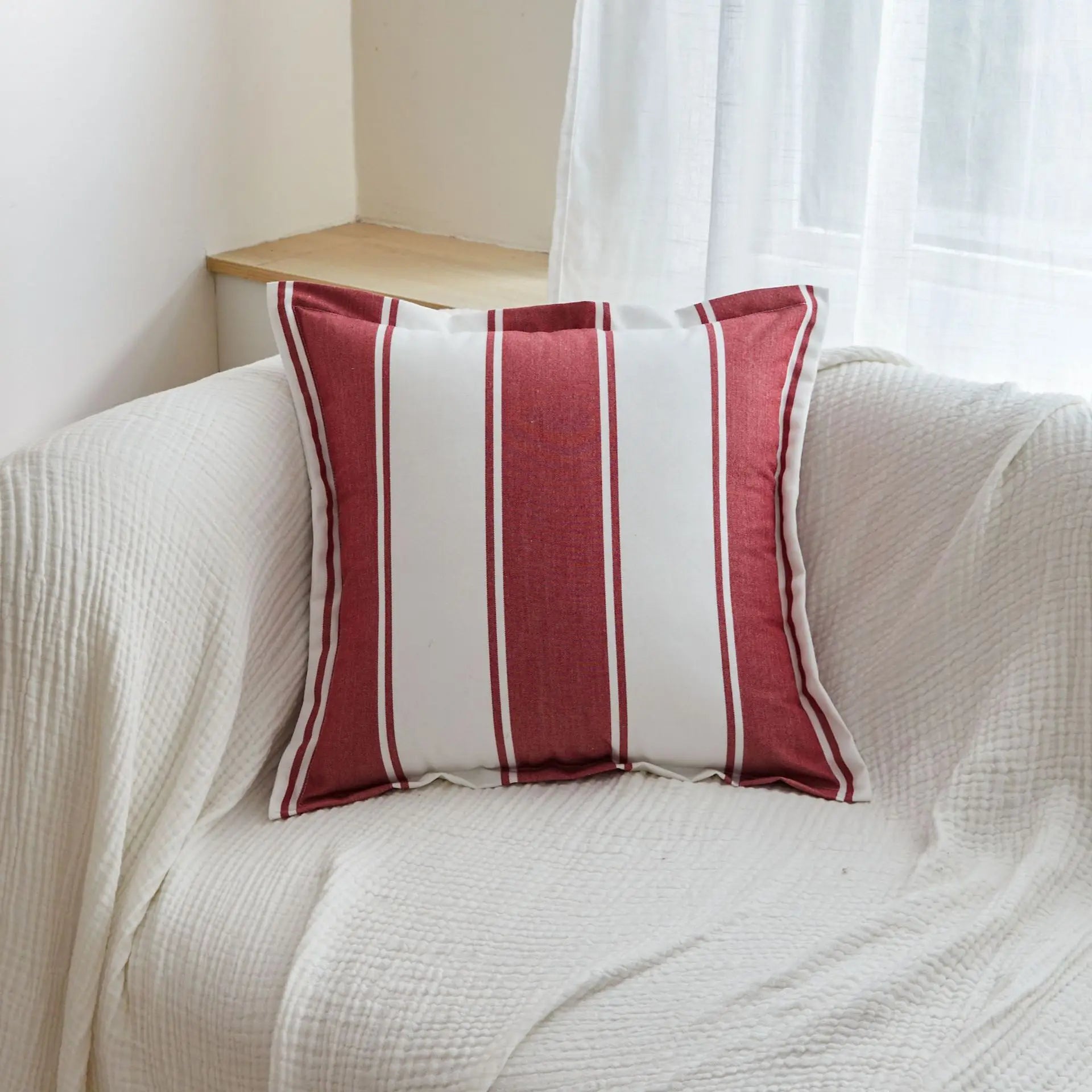 Red striped tassel pillow cover with farmhouse pattern and decorative fringe detail