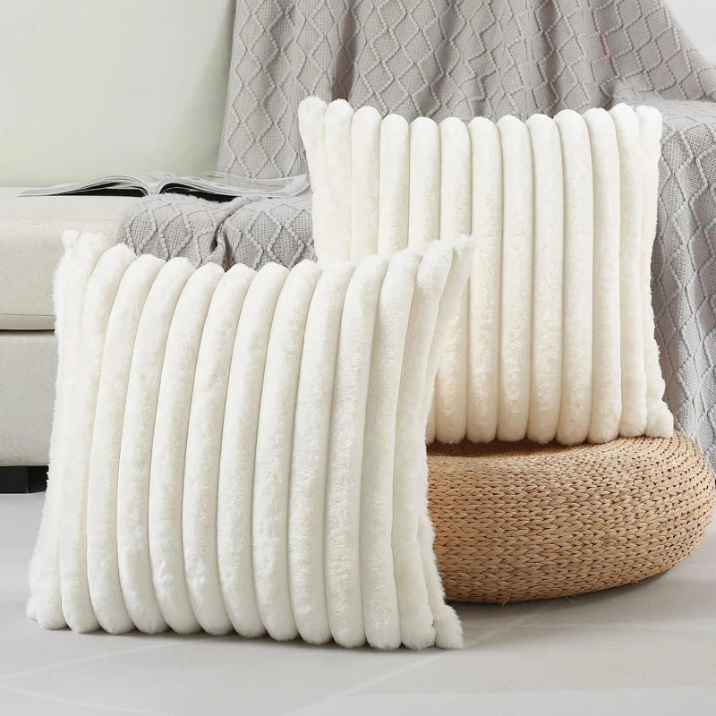 Two white textured pillows on a neutral background