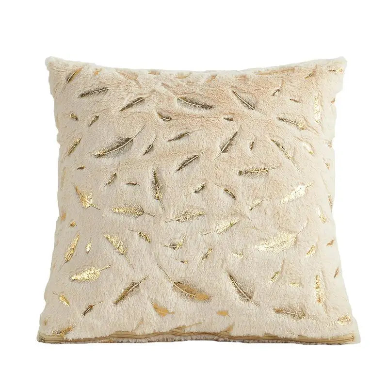 Decorative pillow with gold leaf pattern on a white background