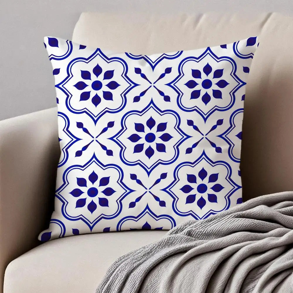 Decorative pillow with blue and white pattern on a beige couch.
