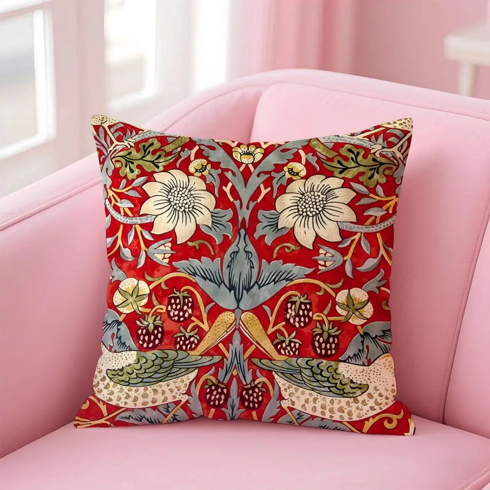 Decorative pillow with floral and bird pattern on a pink couch