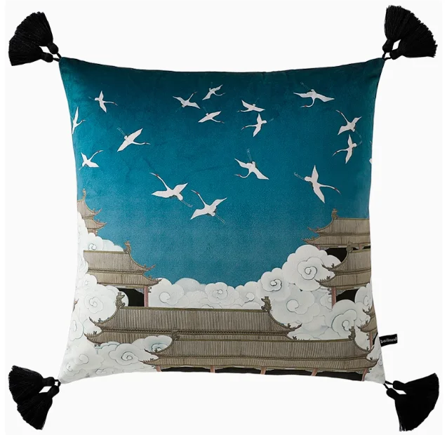 Decorative pillow with Japanese temple and crane design on a blue background