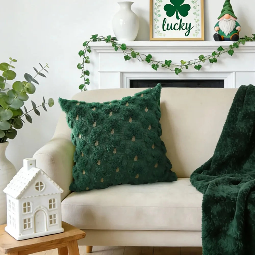 Green textured pillow on a beige sofa with festive decorations in a living room.