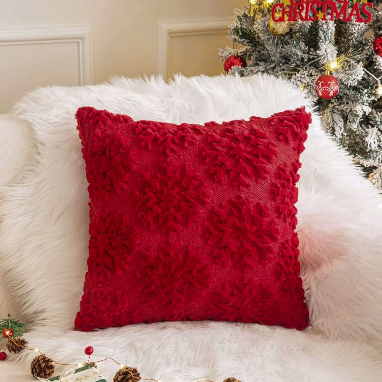 Red faux fur Christmas pillow cover with textured festive design on sofa