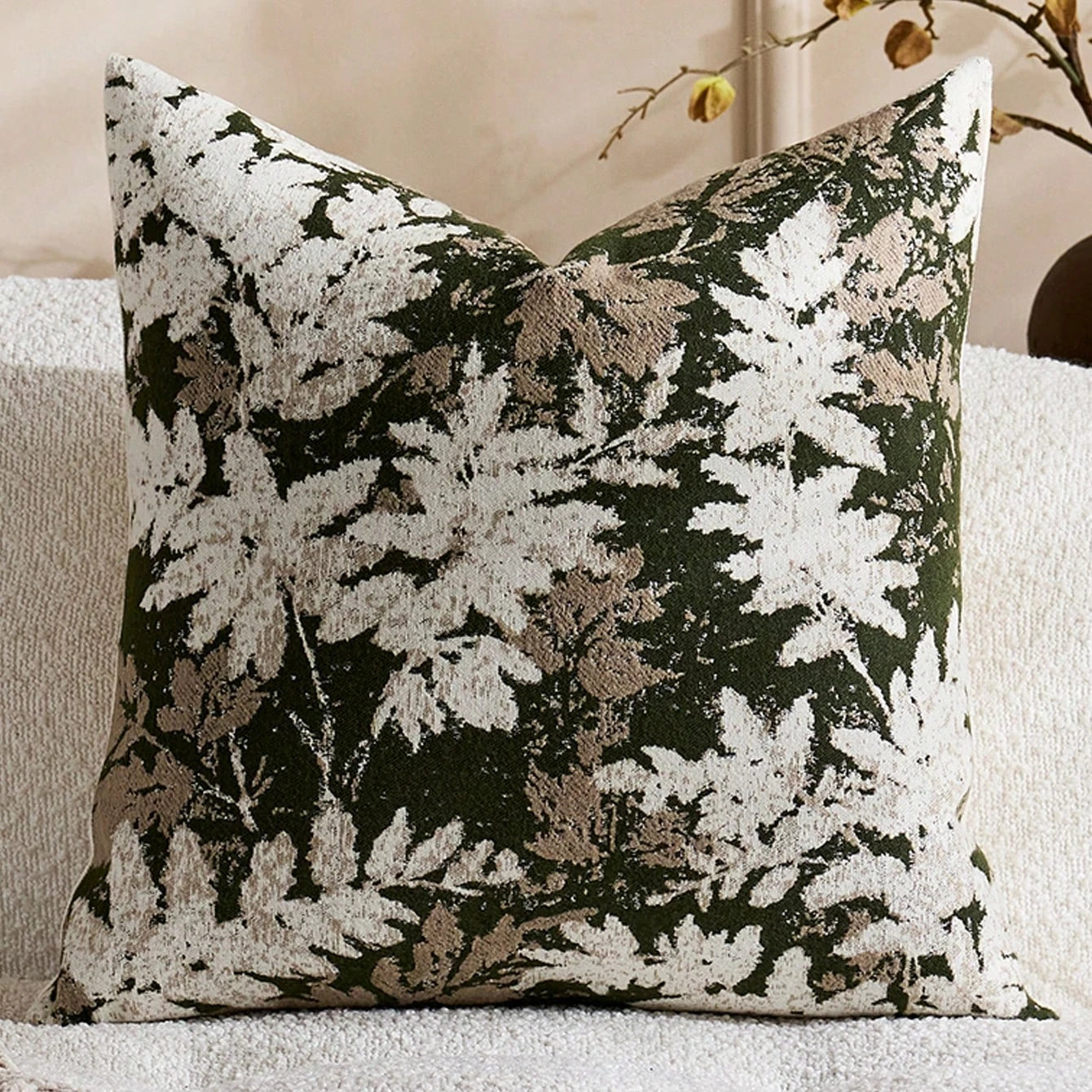 Decorative pillow with leaf pattern on a neutral background