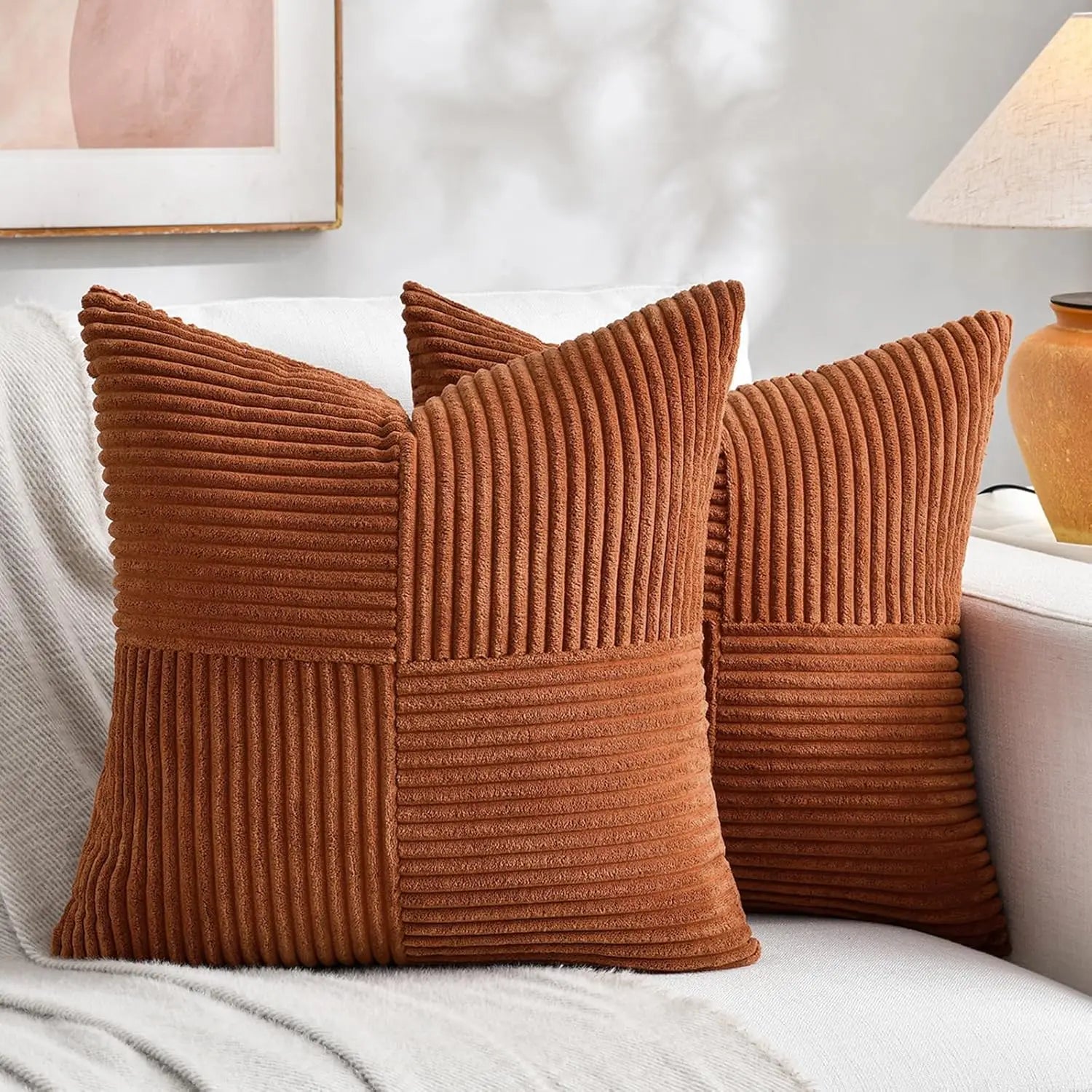 Brown corduroy striped pillow covers with textured fabric on sofa