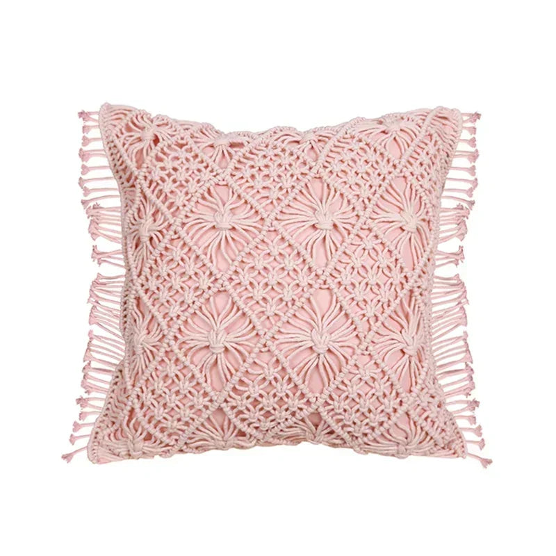 Pink crochet pillow with fringe on a white background