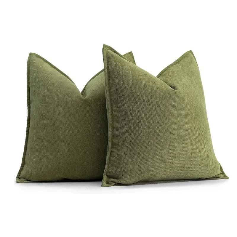 Two green pillows on a white background